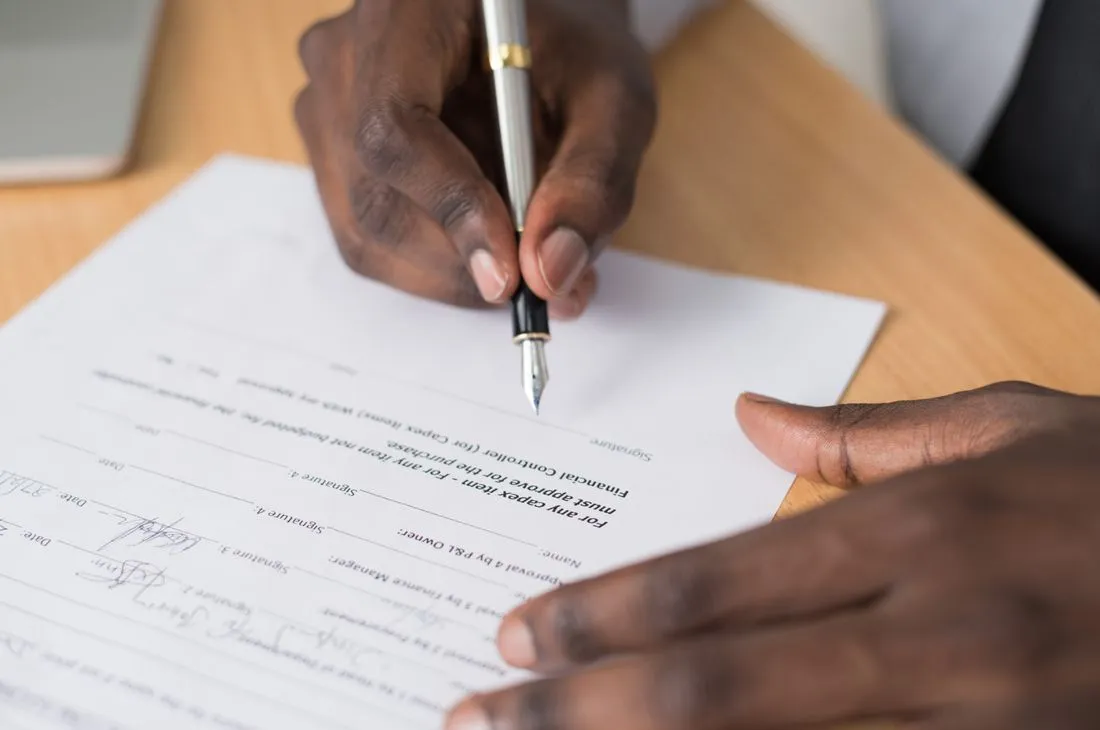 Policy paperwork and reading glasses on a desk